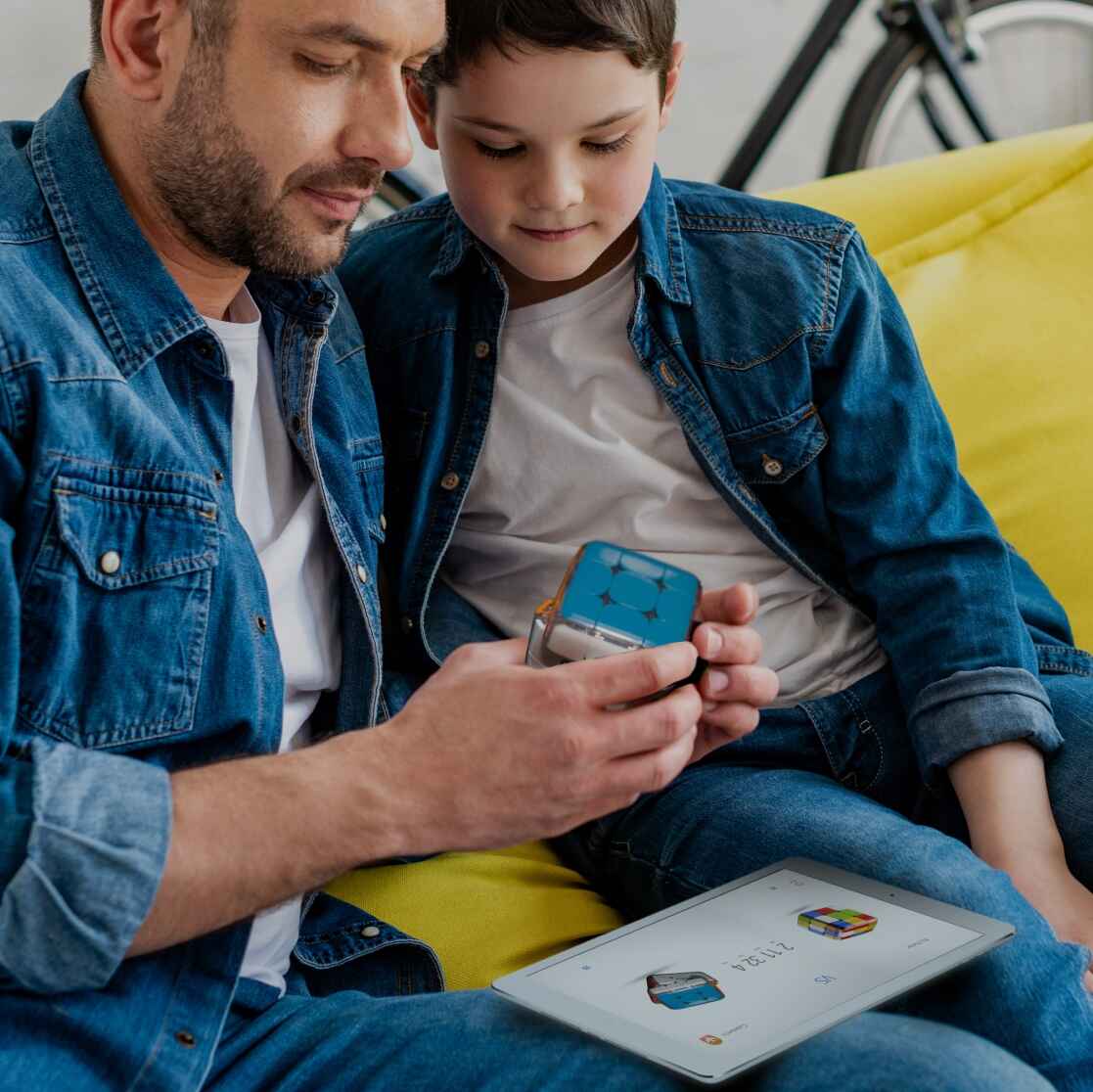 father and son playing with Smart Rubik's Cube