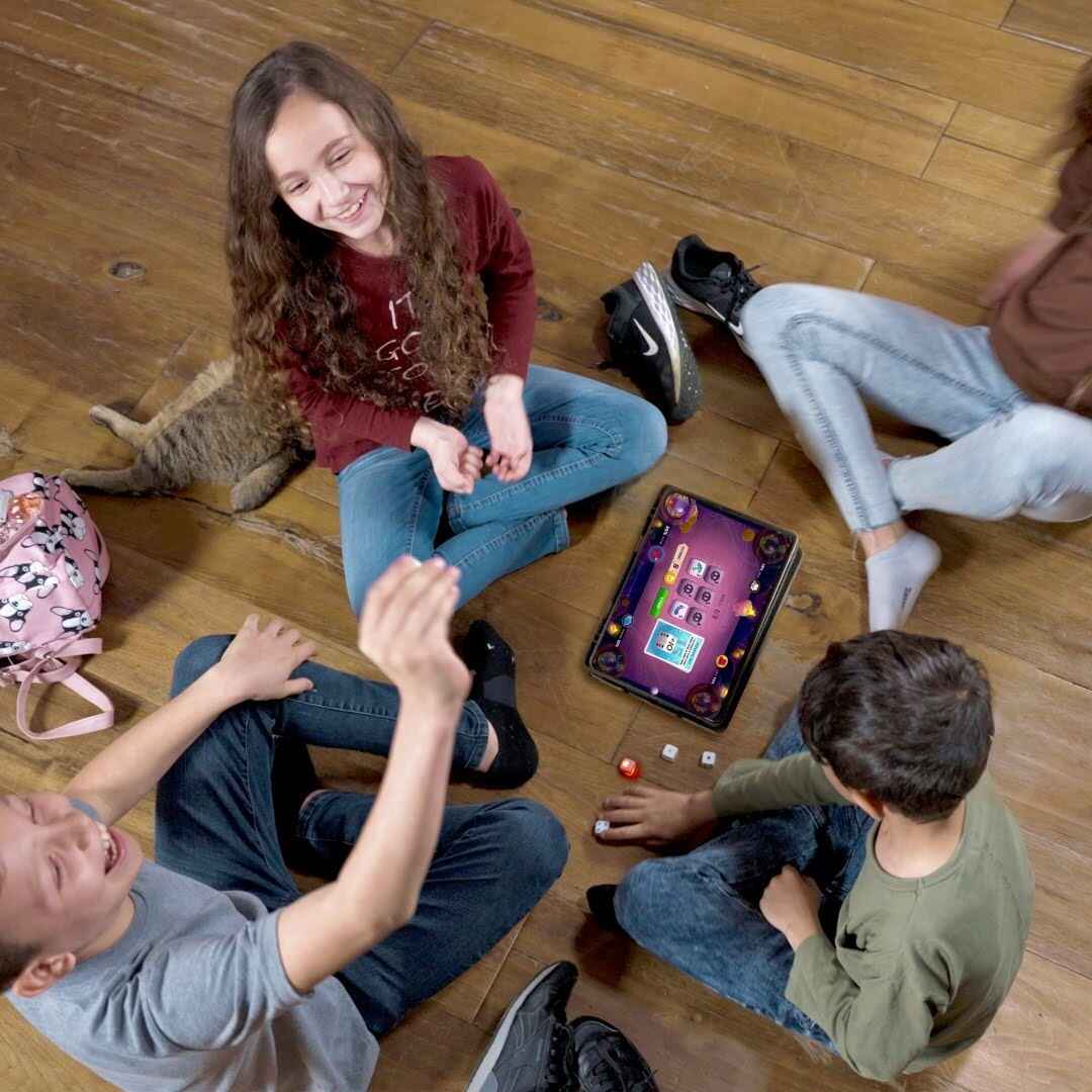 kids playing board games with bluetooth dice